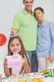 Little girl holding a birthday gift