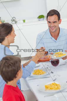 Woman serving husband during the dinner