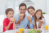 Family eating pizza slices