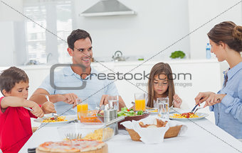 Family eating pasta with sauce