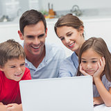 Parents and children using a laptop