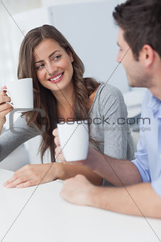 Cheerful couple drinking a cup of coffee
