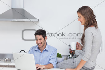 Man using his laptop in the kitchen