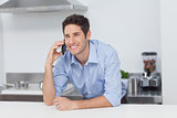 Man having a phone conversation in the kitchen