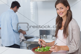 Woman mixing a salad in the kitchen