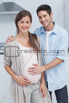 Man touching the belly of his pregnant wife