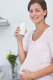 Pregnant woman drinking a glass of milk