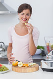 Pregnant woman eating a grape