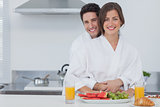 Portrait of a man embracing his wife in the kitchen