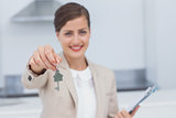 Pretty real estate agent giving house key