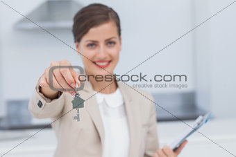 Pretty real estate agent giving house key