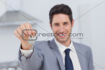 Real estate agent presenting house key