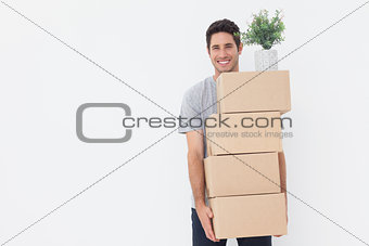 Man carrying boxes because he is moving in a new house