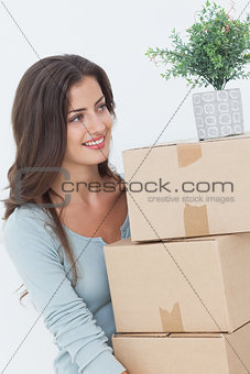 Woman holding boxes because she is moving