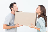 Cheerful woman and her husband holding a box