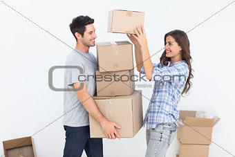 Woman giving boxes to her husband while they are moving