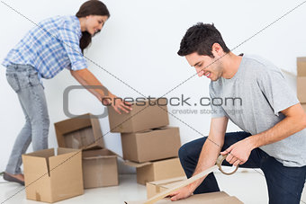 Woman and man wrapping boxes