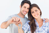 Man and wife holding a key with a house keychain