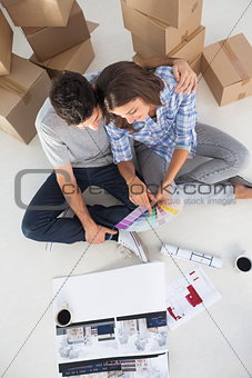 Overview of a man and his wife looking at house plans