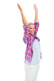 Happy woman standing with hands up in air