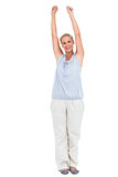Excited woman standing with arms raised