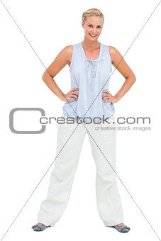 Woman smiling with hands on hips looking at camera