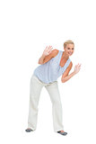 Blonde woman bending down with hands up