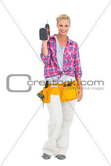 Woman standing holding a drill