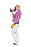 Woman standing with a power drill