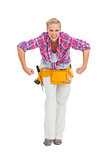 Blonde woman tensing arms wearing tool belt