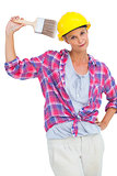 Beautiful handy woman holding a brush and smiling at camera