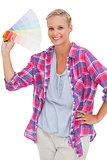 Smiling woman holding color chart