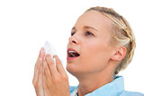 Blonde woman sneezing