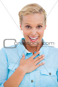 Shocked blonde looking at camera with hand raised