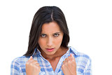 Angry young woman with closed fists looking at camera