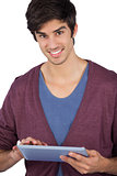 Smiling young man using tablet pc