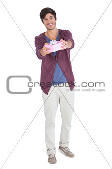 Smiling man offering a gift