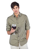 Serious man holding a wine glass
