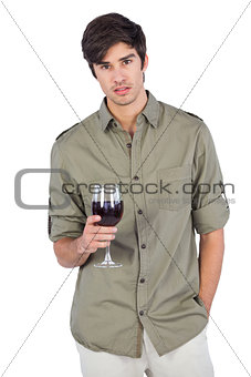 Serious man holding a wine glass