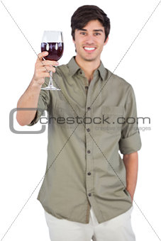 Happy man showing red wine glass
