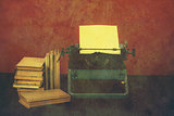 Old typewriter with books retro colors on the desk