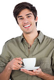 Smiling man holding cup of coffee