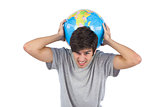 Man suffering while holding a globe