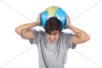 Man suffering while holding a globe