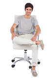Smiling man sitting on a swivel chair