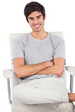 Smiling man with arms crossed sitting on a swivel chair