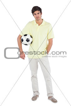 Young man holding soccer ball