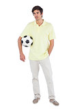 Serious man holding soccer ball