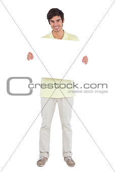 Smiling man holding empty sign