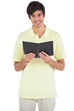 Smiling student holding a notebook